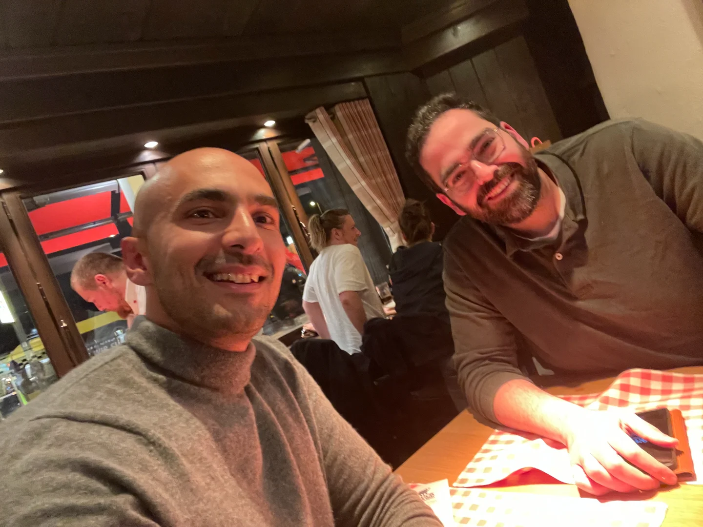 Two people together at a restaurant table.